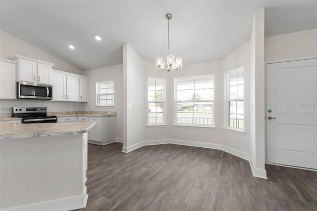 13 Primrose Ln, Palm Coast, FL 32164 - kitchen featuring stainless steel microwave, electric stove, white cabinetry, a chandelier, and dark wood-type flooring