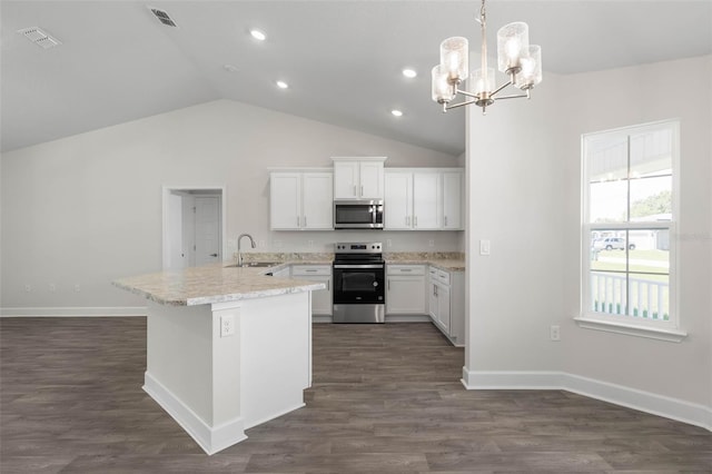 13 Primrose Ln, Palm Coast, FL 32164 - kitchen with appliances with stainless steel finishes, a sink, a chandelier, lofted ceiling, and white cabinetry