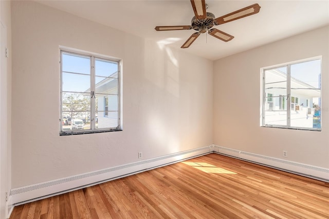 spare room featuring ceiling fan, a baseboard radiator, and light wood-type flooring