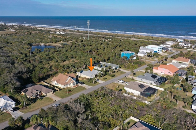 drone / aerial view featuring a water view and a view of the beach