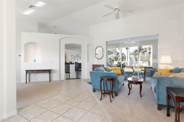 living room with ceiling fan, lofted ceiling, and light tile patterned floors