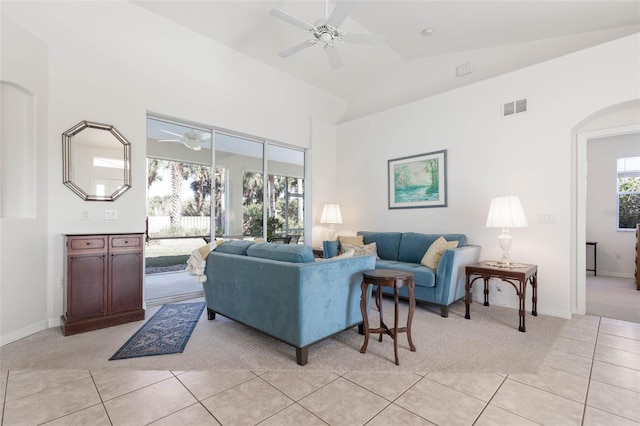 living room with vaulted ceiling, light tile patterned floors, and ceiling fan