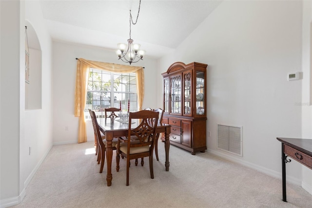 carpeted dining space featuring lofted ceiling and a notable chandelier