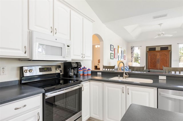 kitchen featuring white cabinetry, appliances with stainless steel finishes, sink, and a healthy amount of sunlight