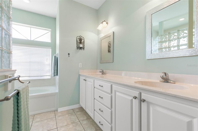 bathroom featuring tile patterned flooring, vanity, and a tub to relax in