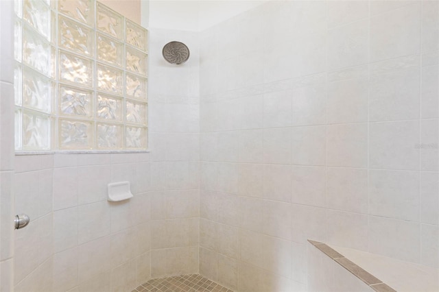 bathroom with tiled shower