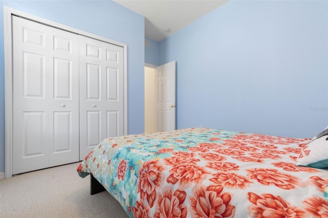 carpeted bedroom with a closet