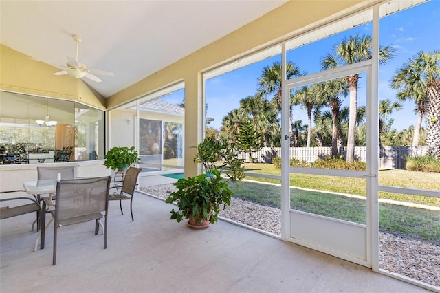 sunroom featuring ceiling fan and vaulted ceiling