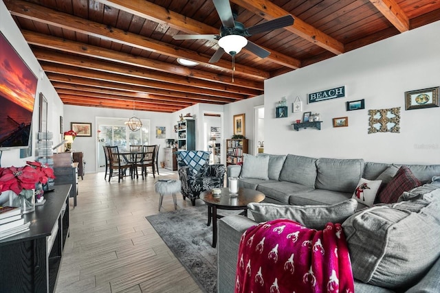 living room with ceiling fan, wood ceiling, wood-type flooring, and beamed ceiling