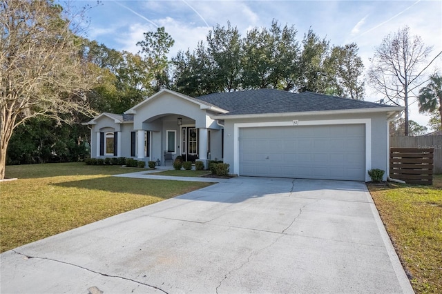 ranch-style house featuring a garage and a front lawn