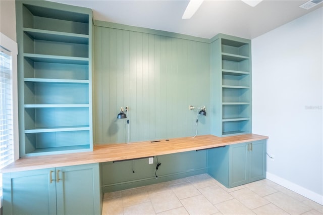 mudroom featuring light tile patterned floors, built in desk, and built in features