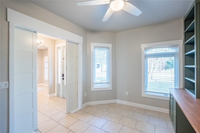 spare room with light tile patterned floors and ceiling fan