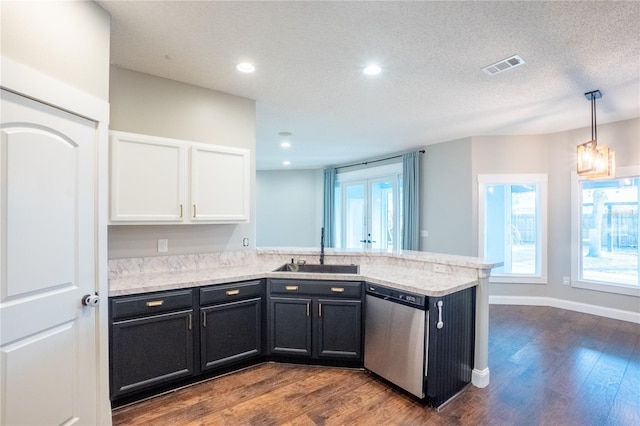 kitchen featuring pendant lighting, dishwasher, sink, white cabinets, and kitchen peninsula