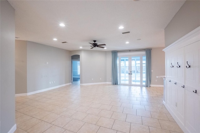 unfurnished room with french doors and ceiling fan