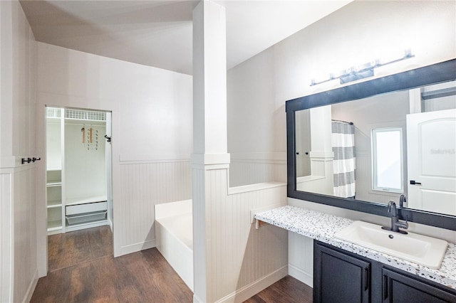 bathroom featuring hardwood / wood-style flooring, vanity, and separate shower and tub