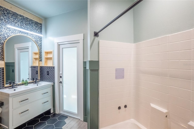 bathroom featuring vanity, bathing tub / shower combination, and tile walls