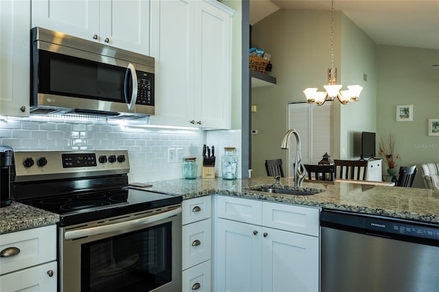 kitchen with white cabinetry, sink, stainless steel appliances, and hanging light fixtures