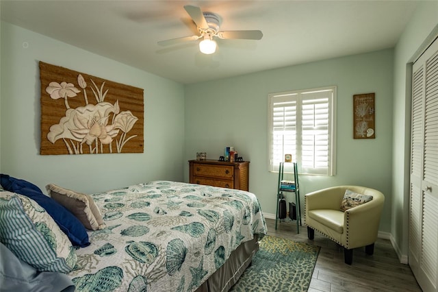 bedroom featuring hardwood / wood-style floors, ceiling fan, and a closet