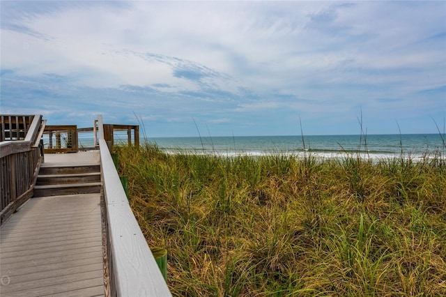 surrounding community featuring a water view and a view of the beach