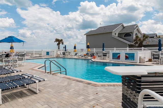 view of swimming pool featuring a patio area