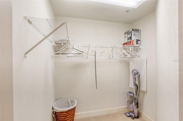 clothes washing area with carpet floors