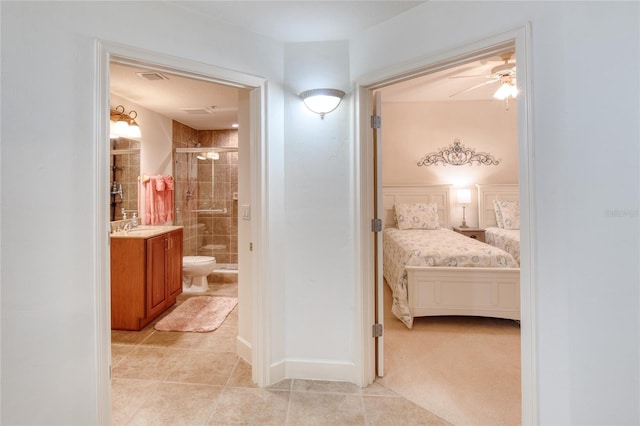 bedroom with ensuite bathroom and sink