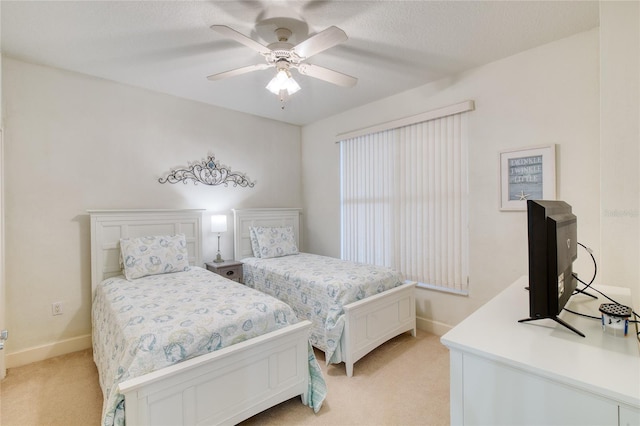 bedroom featuring light colored carpet and ceiling fan