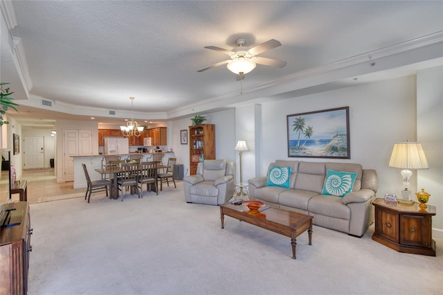 living room with crown molding, ceiling fan with notable chandelier, light colored carpet, and a raised ceiling