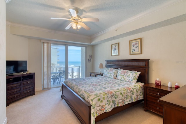 carpeted bedroom featuring ceiling fan, a water view, ornamental molding, a textured ceiling, and access to outside