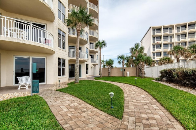 view of home's community with a yard and a patio