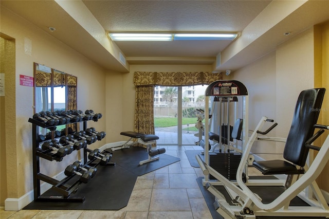 gym featuring plenty of natural light and a textured ceiling