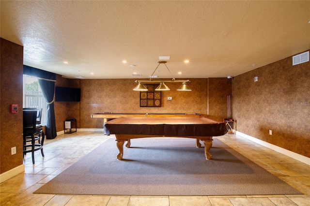 rec room with light tile patterned flooring, billiards, and a textured ceiling