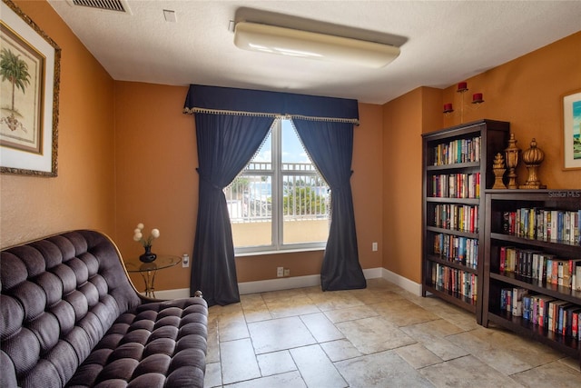 sitting room featuring a textured ceiling