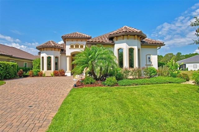 mediterranean / spanish-style house featuring a front yard