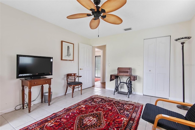 living area featuring ceiling fan, tile patterned flooring, visible vents, and baseboards