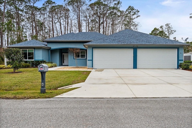 view of front of property with a garage and a front yard