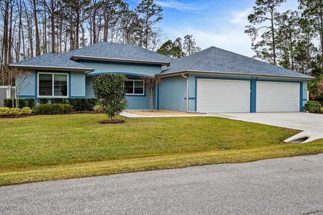 view of front of house featuring a garage and a front lawn