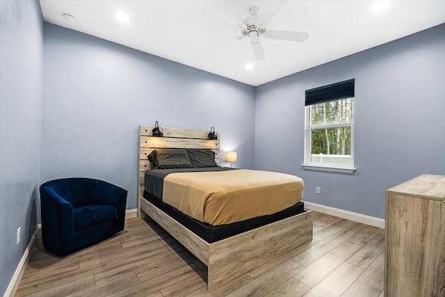 bedroom with ceiling fan and light wood-type flooring