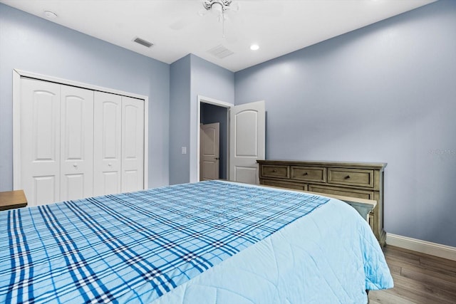 bedroom with ceiling fan, hardwood / wood-style floors, and a closet