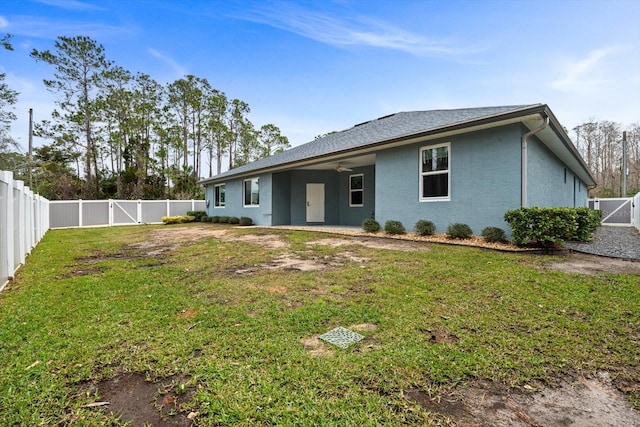 rear view of property featuring a yard