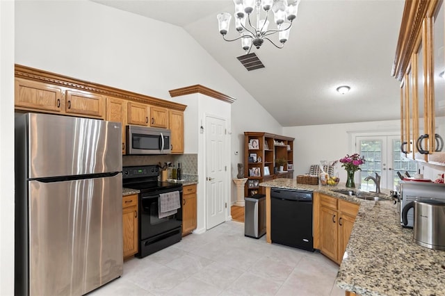 kitchen featuring light stone countertops, lofted ceiling, pendant lighting, and black appliances