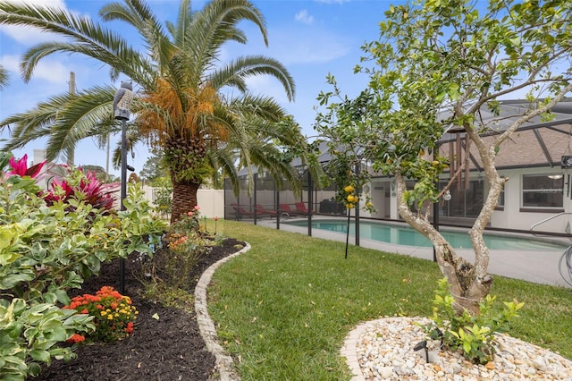 view of swimming pool with a yard and a lanai