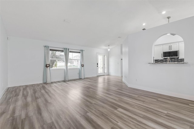 unfurnished living room featuring light wood-type flooring