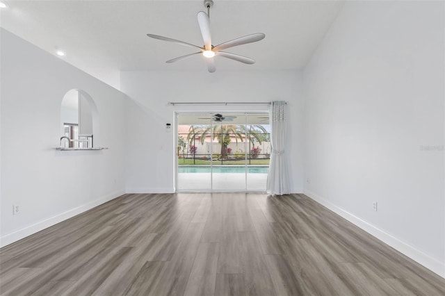 spare room featuring hardwood / wood-style flooring and ceiling fan