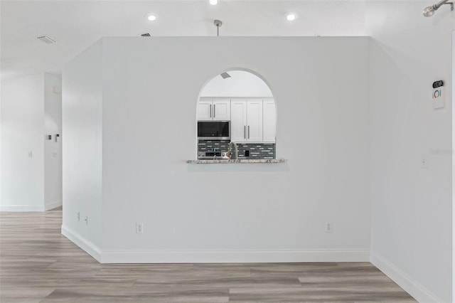 empty room with light hardwood / wood-style floors