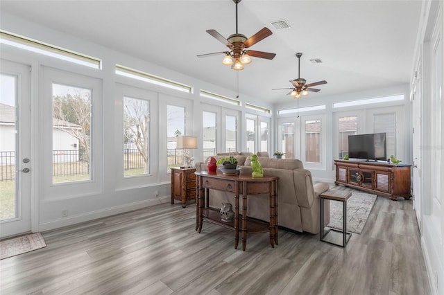 living room featuring hardwood / wood-style floors and ceiling fan