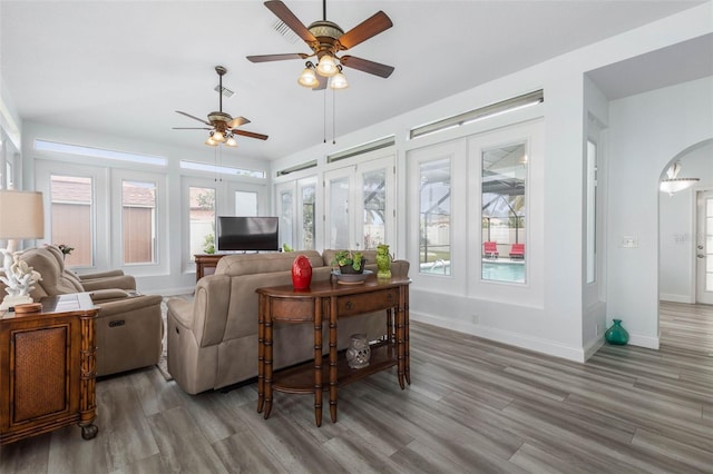 living room with hardwood / wood-style floors and ceiling fan