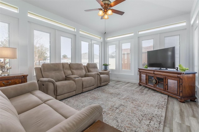 living room featuring ceiling fan and light hardwood / wood-style floors