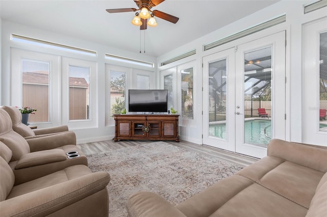 sunroom featuring french doors and ceiling fan