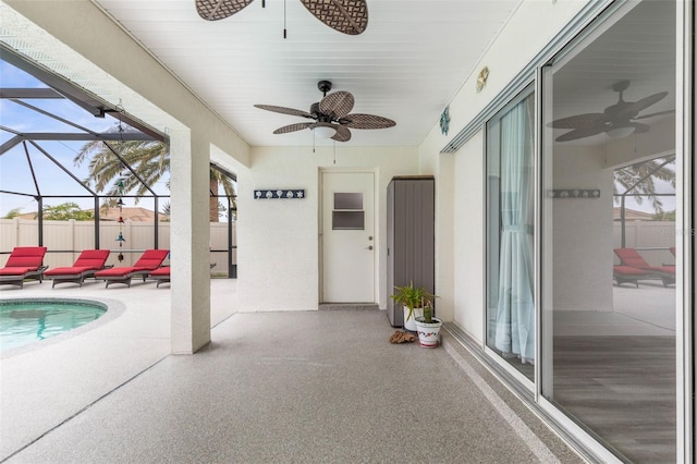 view of patio / terrace featuring ceiling fan, a fenced in pool, and glass enclosure